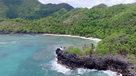 aerial orbit shot of empty playa ermitano with beautiful scenery in background - coral reef underwater in samana, dominican republic