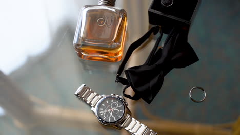 groom's accessories with the bow tie on the table for the wedding day - top view