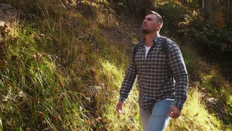 man hiking in autumn forest