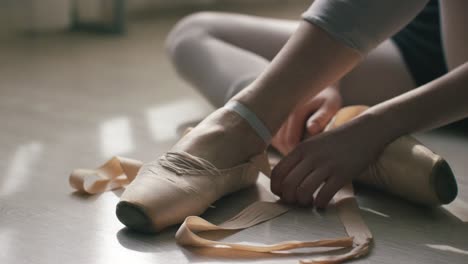 ballet dancer tying shoes