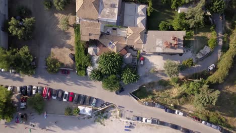 Flying-above-Mediterranean-sea-onto-beach,-top-view-aerial