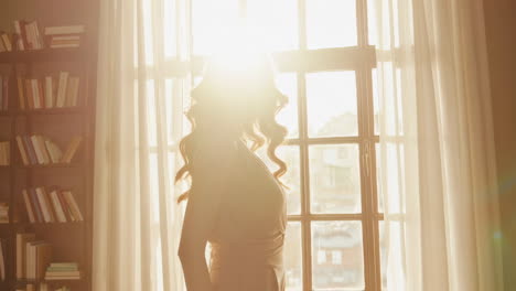 woman in a library with natural sunlight