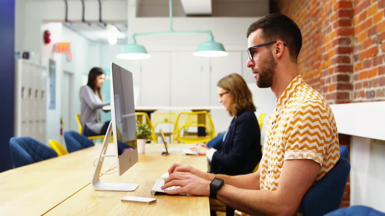 grupo de ejecutivos discutiendo sobre la computadora en el escritorio