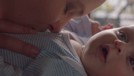 close up mother kissing happy baby laughing enjoying loving mom nurturing toddler at home