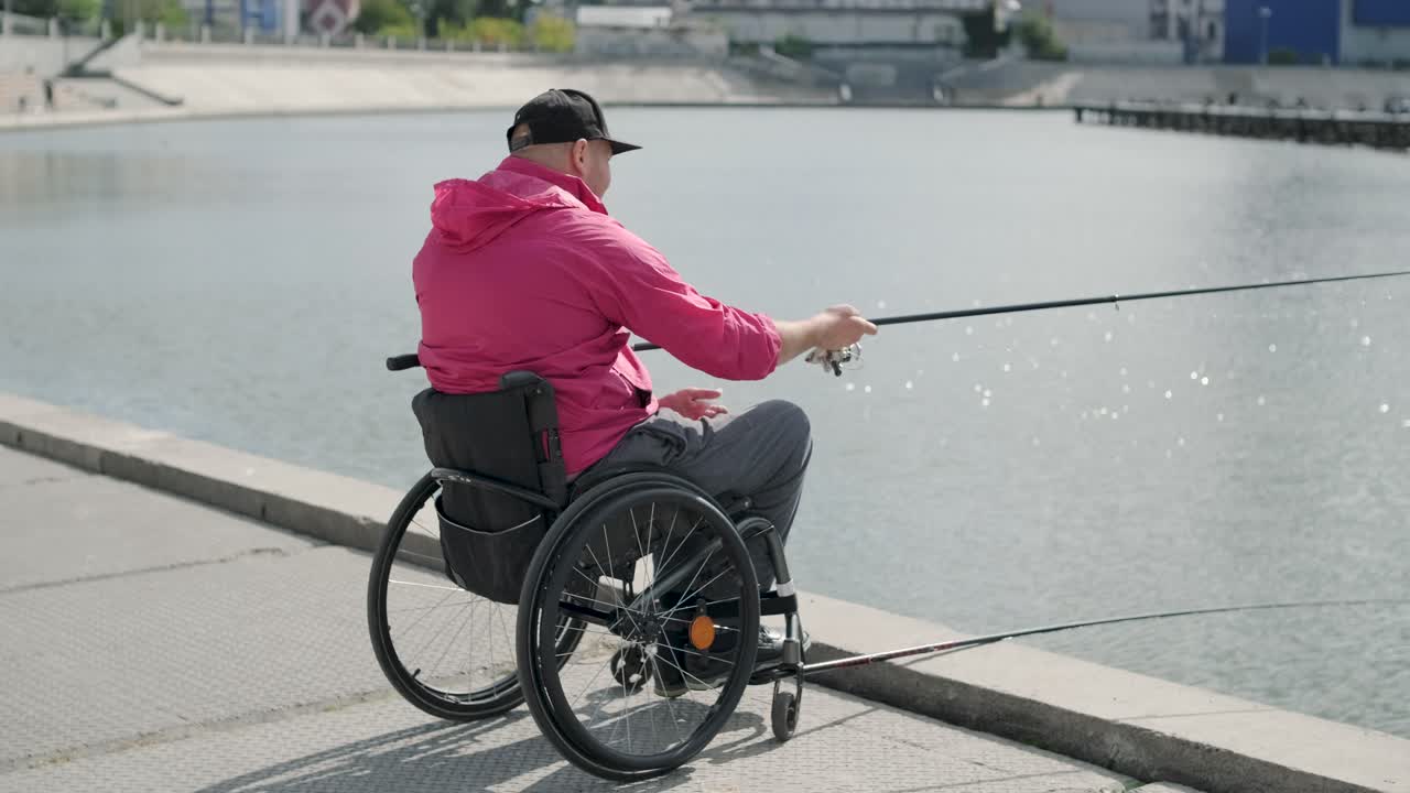 Person with a physical disability who uses wheelchair fishing from fishing pier