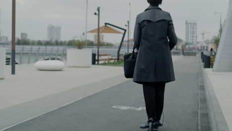 businessperson using electric scooter in urban setting