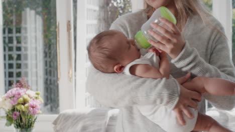 mother feeding baby drinking from milk bottle loving mom caring for infant at home motherhood responsibility 4k