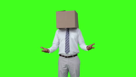 businessman with box over head and shrugging