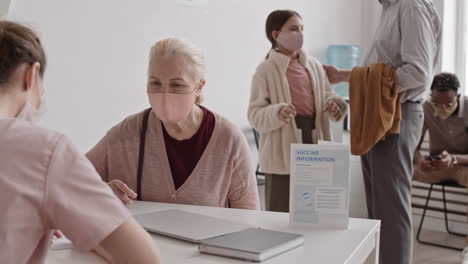 senior female patient showing registration card