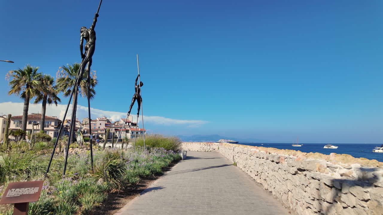 View of bronze sculptures by Nicolas Lavarenne on the coast of the city, Antibes, France