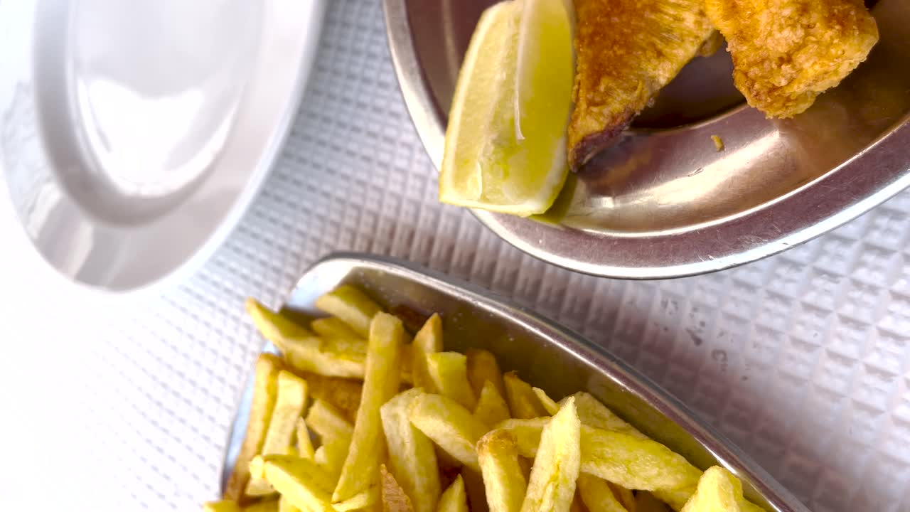Vertical Close-up of Golden-Fried Seafood with Lemon and Fried Chips in Lisbon, Portugal