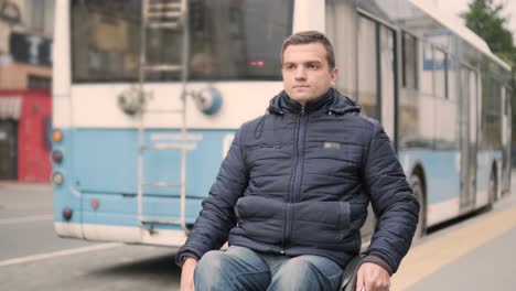person with a physical disability waiting for city transport with an accessible ramp