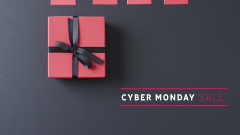 animation of cyber monday sale text over gift boxes