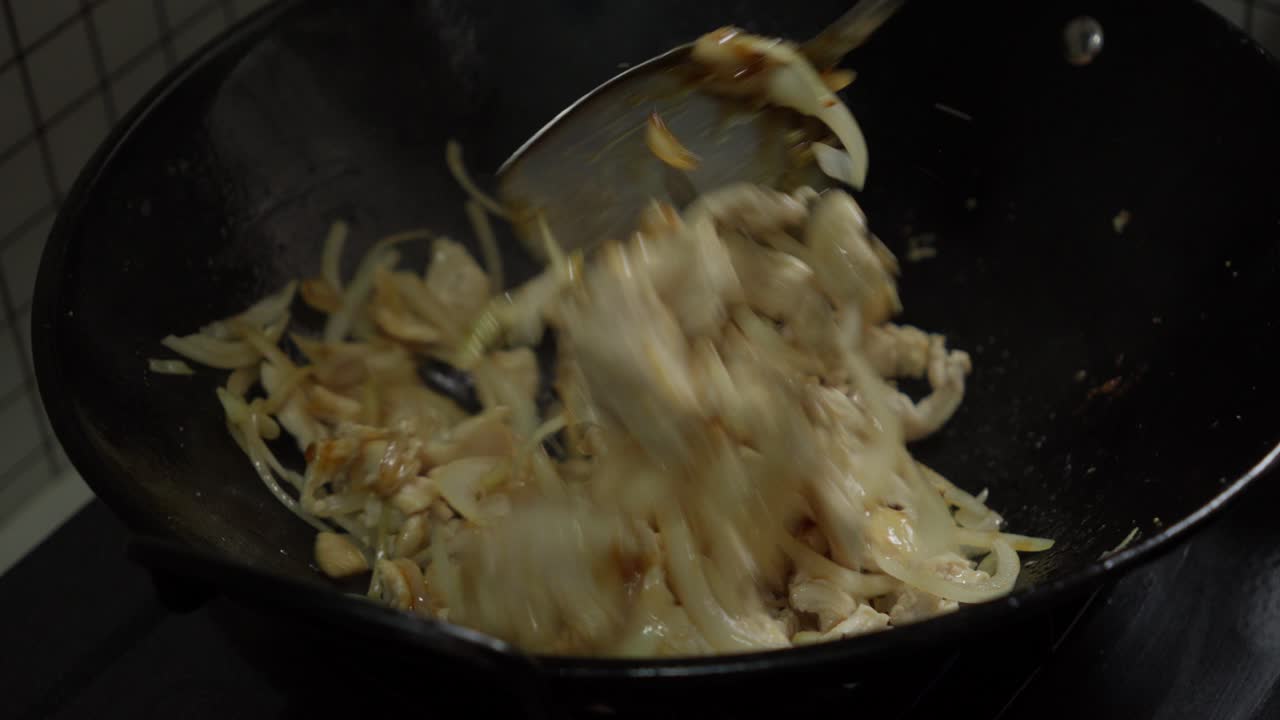 Sauteing White Onions And Chicken Breast Meat On A Chinese Metal Wok