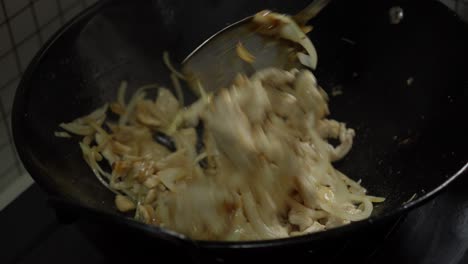 Sauteing White Onions And Chicken Breast Meat On A Chinese Metal Wok