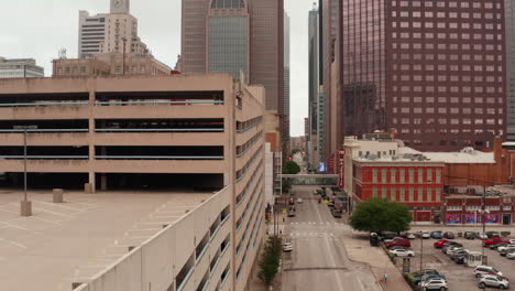 Elevated-view-from-drone-moving-over-Elm-street-in-downtown.-Aerial-view-of-tall-business-buildings.-Multi-storey-office-blocks.-Dallas,-Texas,-US