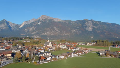 breathtaking morning flight to church in village of tirol austria, drone push in