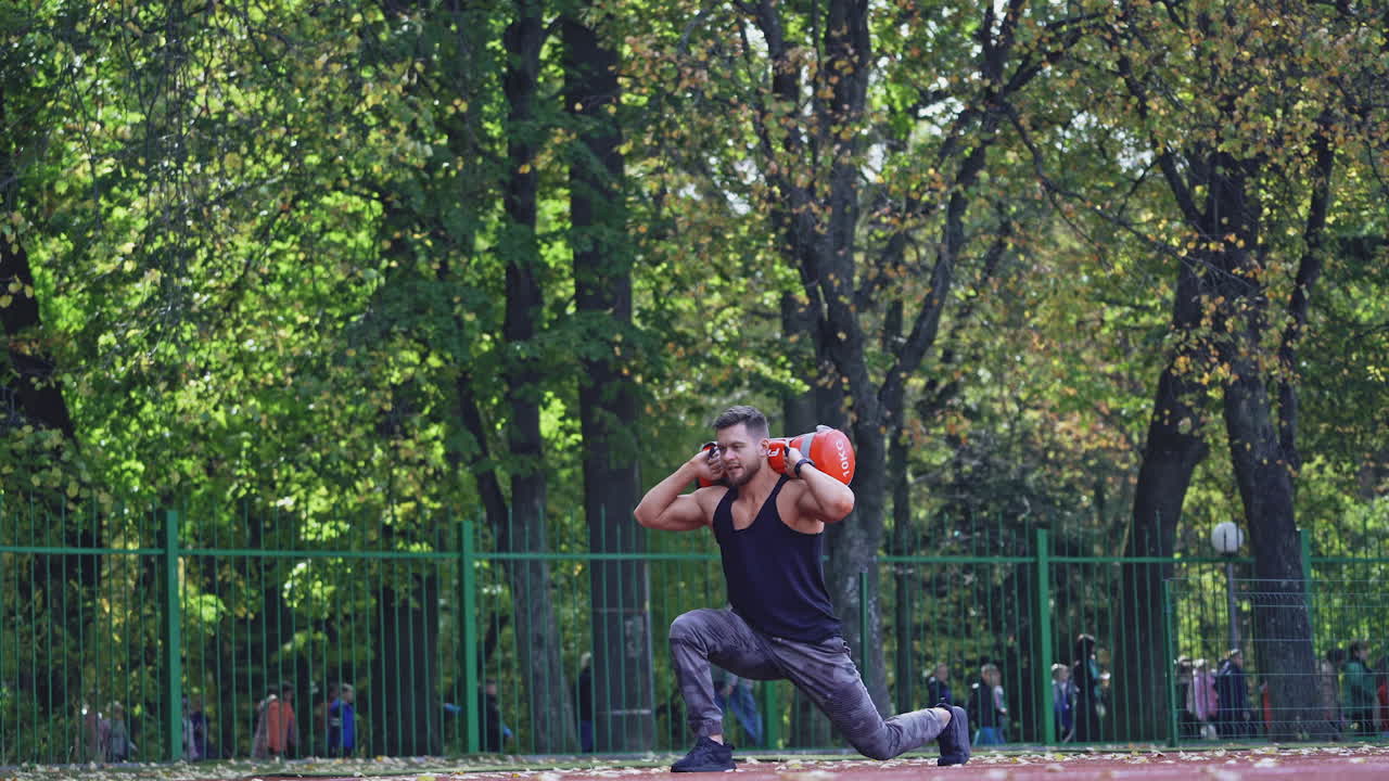 Man training at stadium. Fit athlete doing exercises at stadium
