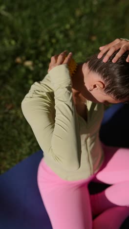 woman performing neck and shoulder self-massage