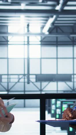 vertical video server room admins looking over financial documents