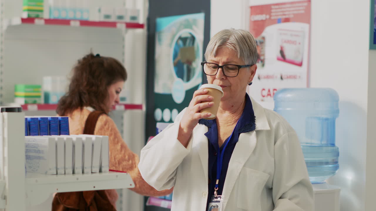 Pharmacist Taking a Break with Coffee in a Pharmacy