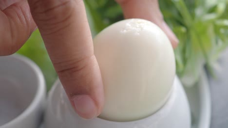 close up of a boiled egg in a white egg cup