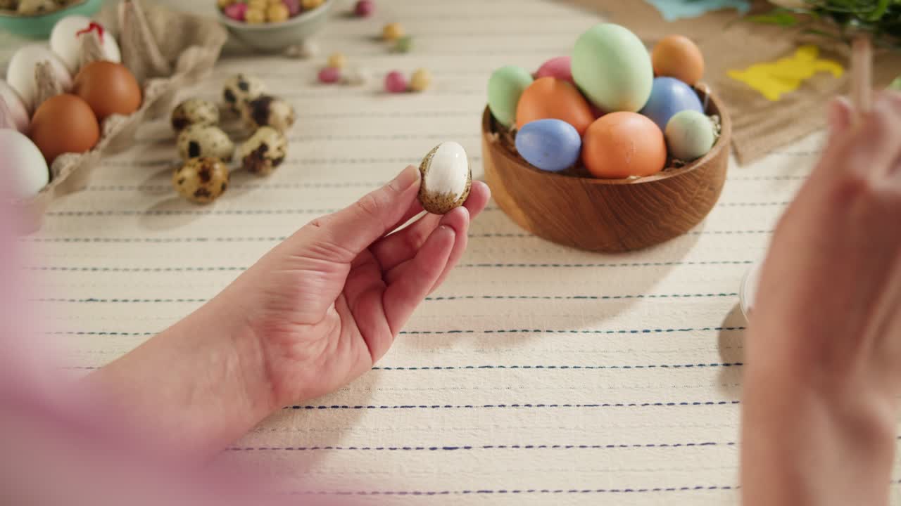 Happy Easter holiday. Coloring eggs top view. Woman preparing for Easter, painting and decorating eggs. Christian celebration, family traditions.