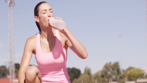 sportswoman drinking water