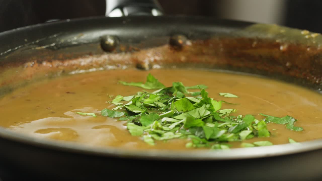 A vibrant platter featuring a variety of traditional Indian dishes, including curries, chutneys, and flatbreads.