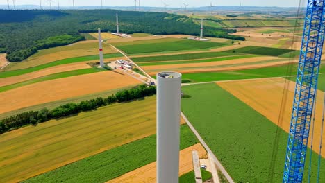 tower of windmill under construction in austria - aerial shot
