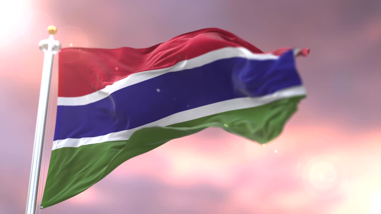 Flag of Gambia waving at wind in slow at sunset, loop