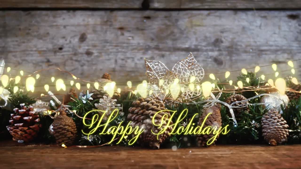 Animation of text, happy holidays, in yellow, over string lights and seasonal decorations