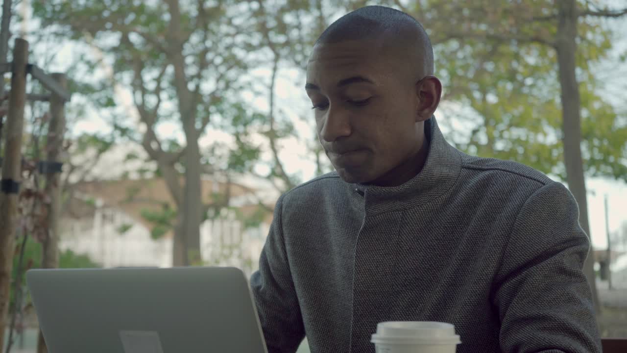 Nervous freelancer working with laptop outdoor