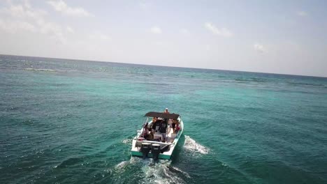 boat cruising on caribbean ocean water in belize