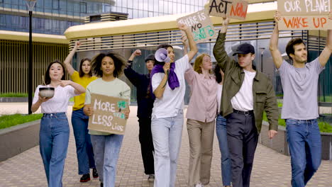 multicultural group protesting for saving the planet while walk towards the camera 1