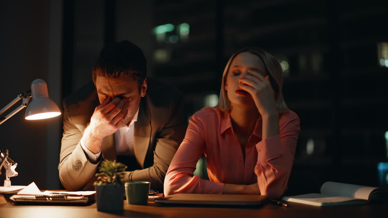 Exhausted Employees Working Late at the Office