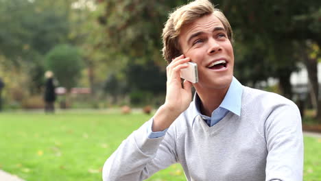 man-using-mobile-phone-outdoors-in-park