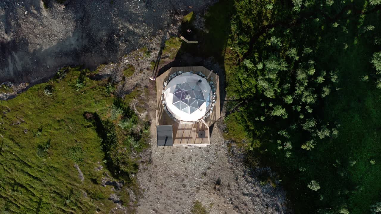 Glamping in an acrtic dome in the north of Norway, aerial shot. Small house for vacation in a beautiful nature.