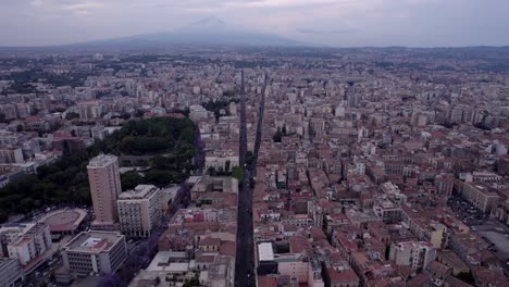 Aerial-of-Sicilian-town-Catania-with-Mt-Etna-volcano,-Sicily,-Italy