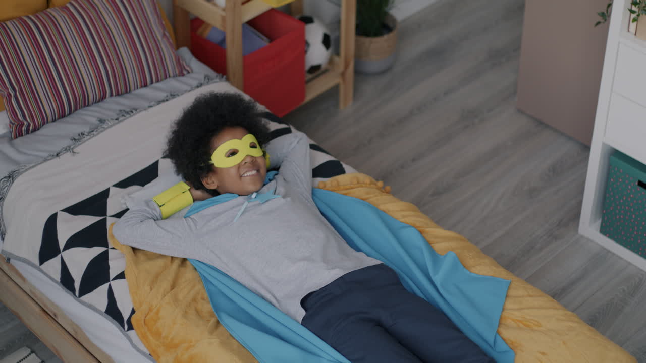 Child Playing Superhero in Bedroom