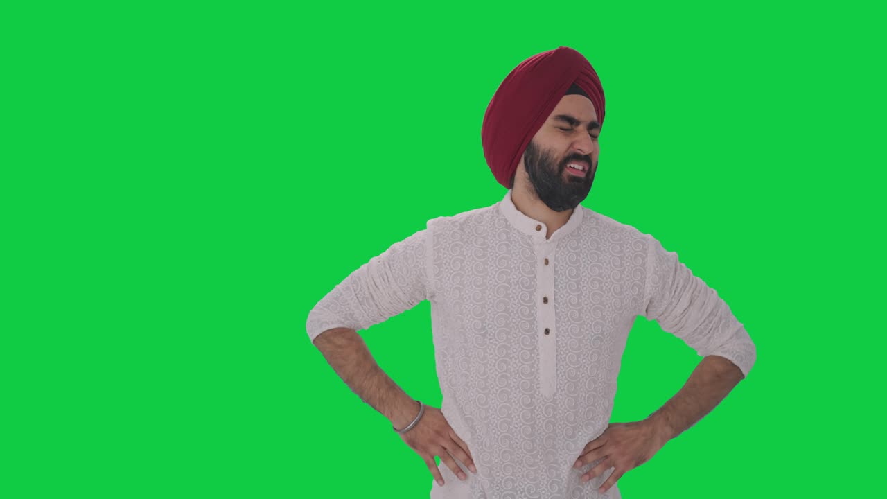 Uomo indiano Sikh malato che soffre di mal di stomaco - Green screen