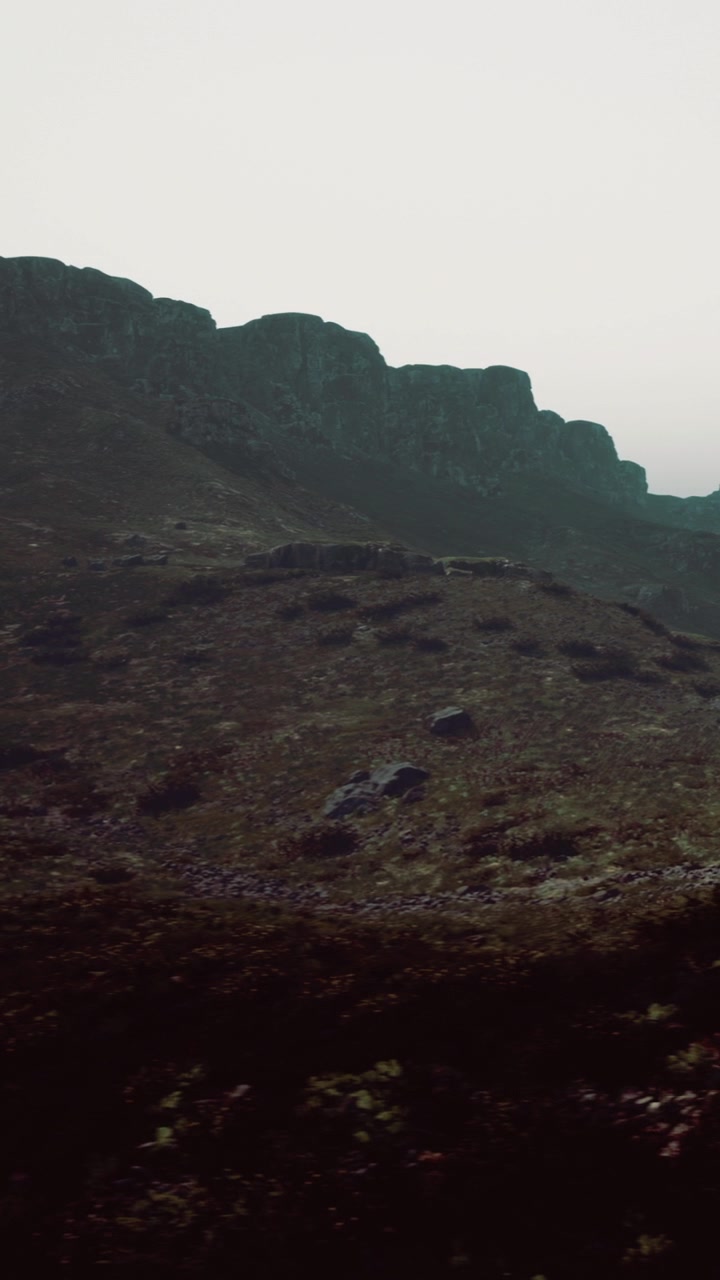 Mountains and rocky terrain in a misty setting during the day