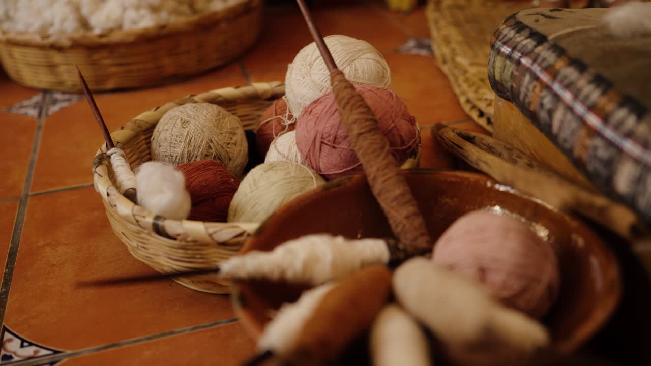 Handspun yarn balls and wooden spindles in a Guatemalan textile studio