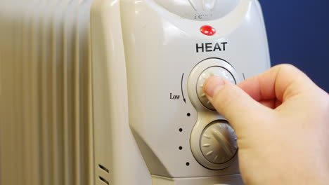 a man is turning the heating up on a radiator