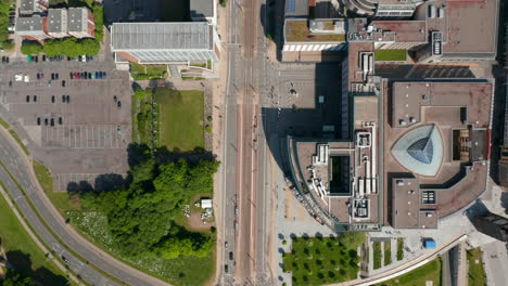 Aerial-birds-eye-overhead-top-down-view-of-low-traffic-in-city-streets.-Flying-above-various-buildings,-modern-shopping-centre,-office-and-residential-buildings