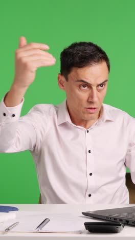 Office worker reacting with surprise and perplexity at laptop on green screen