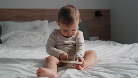 Video-of-caucasian-little-girl-using-mobile-phone-at-home.