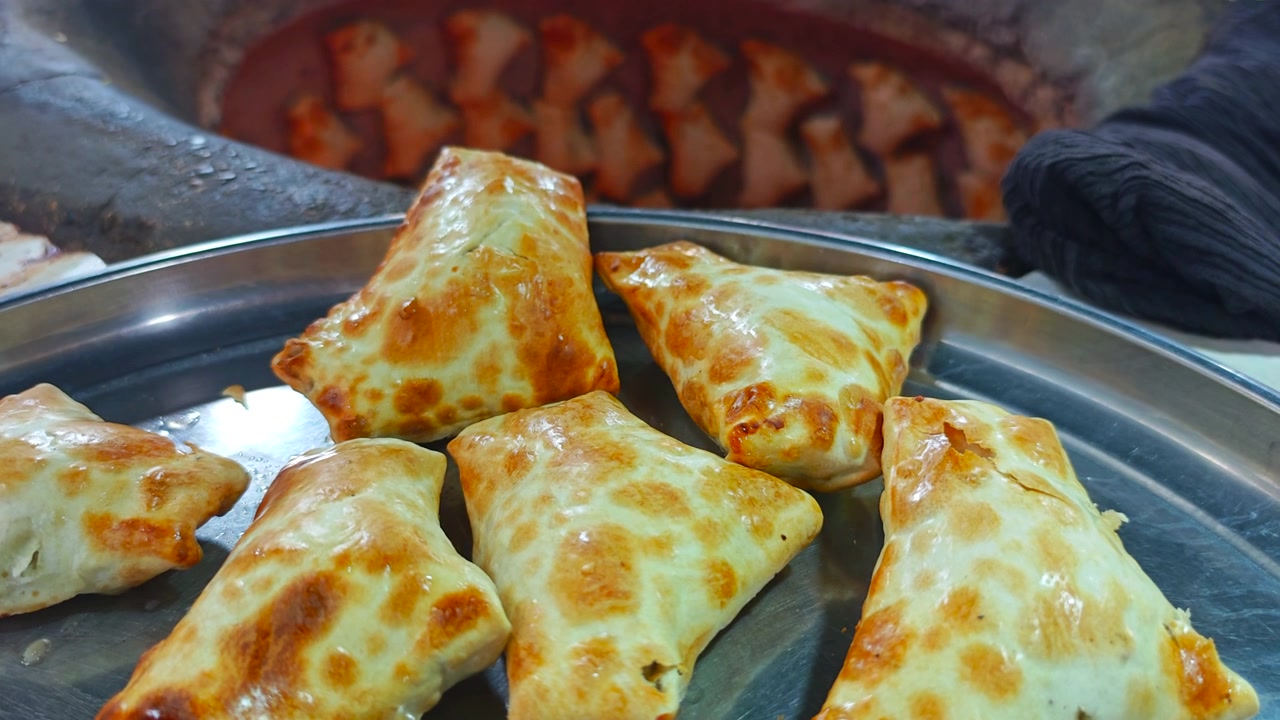 Pasticcini Samsa appena sfornati su un vassoio di metallo