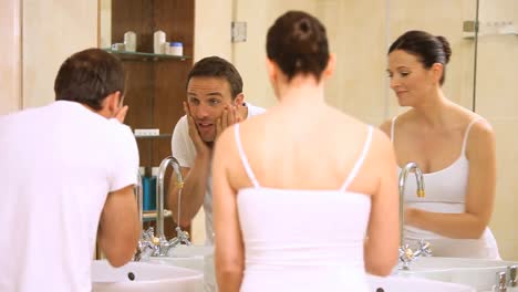 couple getting ready in the bathroom