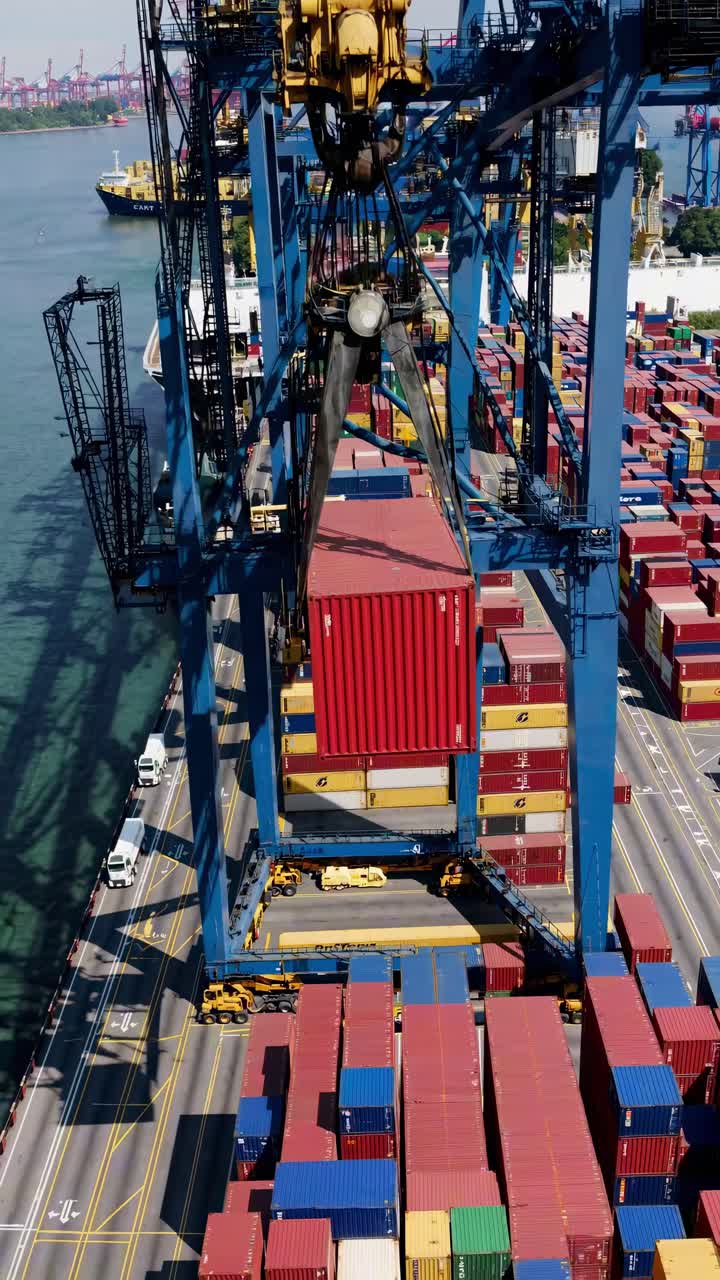 Aerial view of a busy port with colorful shipping containers and cranes